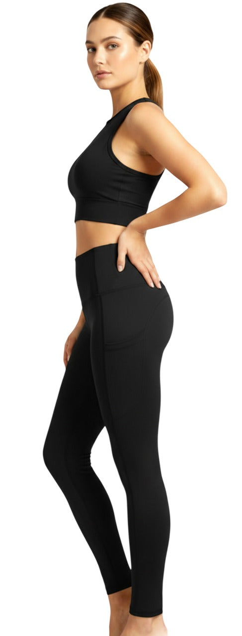 Woman wearing a black athletic outfit on a white background