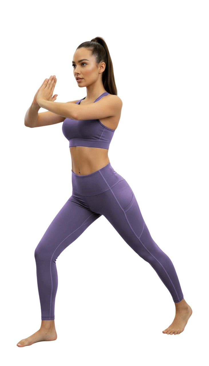 Woman in purple athletic wear posing on a white background