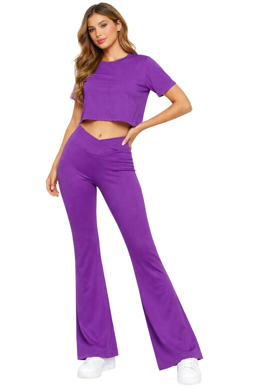 Woman wearing a purple outfit with a matching top and pants on a white background