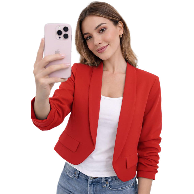 Woman in a red blazer taking a selfie on a white background