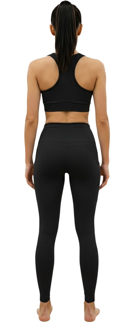 Person wearing a black athletic outfit on a white background