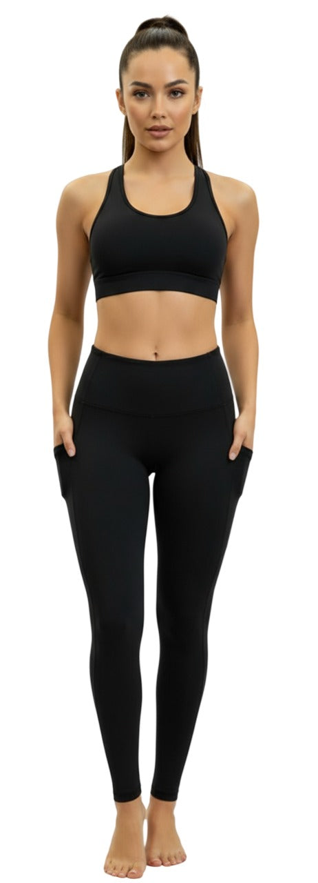 Woman wearing a black sports bra and leggings on a white background