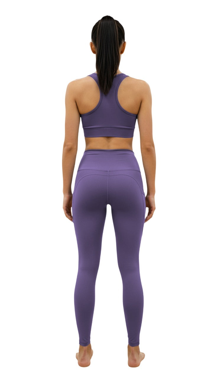 Person wearing a purple athletic outfit on a white background