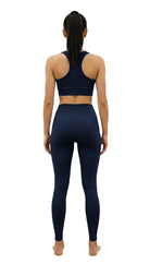 Person wearing a navy blue athletic outfit on a white background
