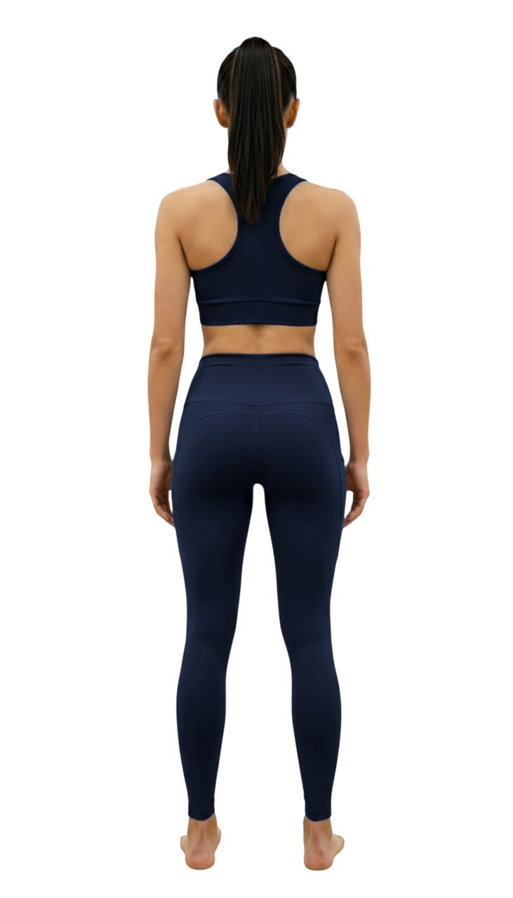 Person wearing a navy blue athletic outfit on a white background