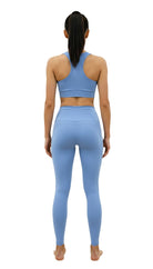 Woman wearing a blue athletic outfit on a white background