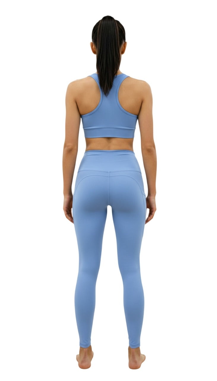 Woman wearing a blue athletic outfit on a white background