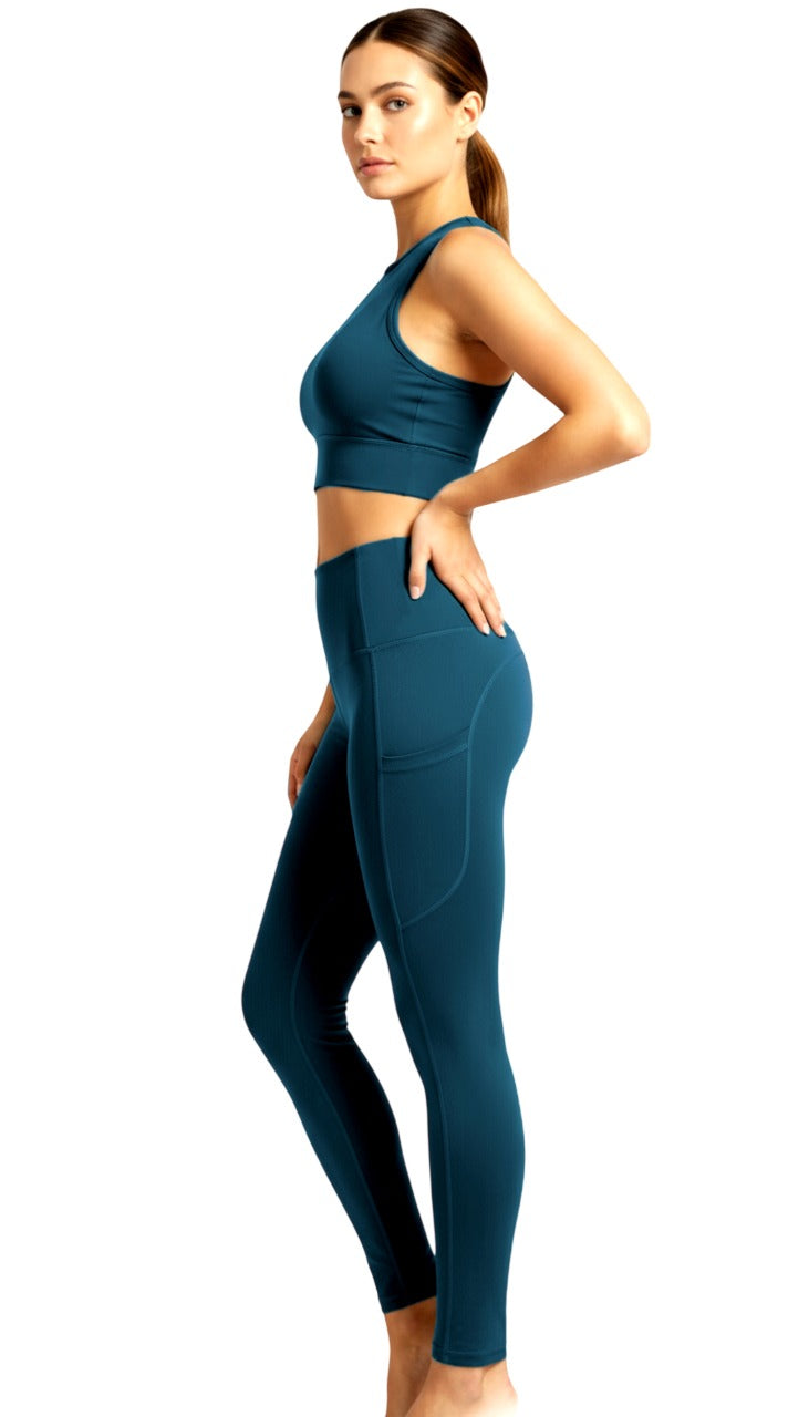 Woman wearing a teal athletic outfit on a white background