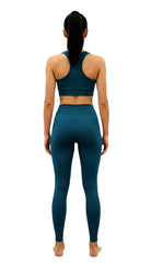 Person wearing teal athletic outfit on a white background