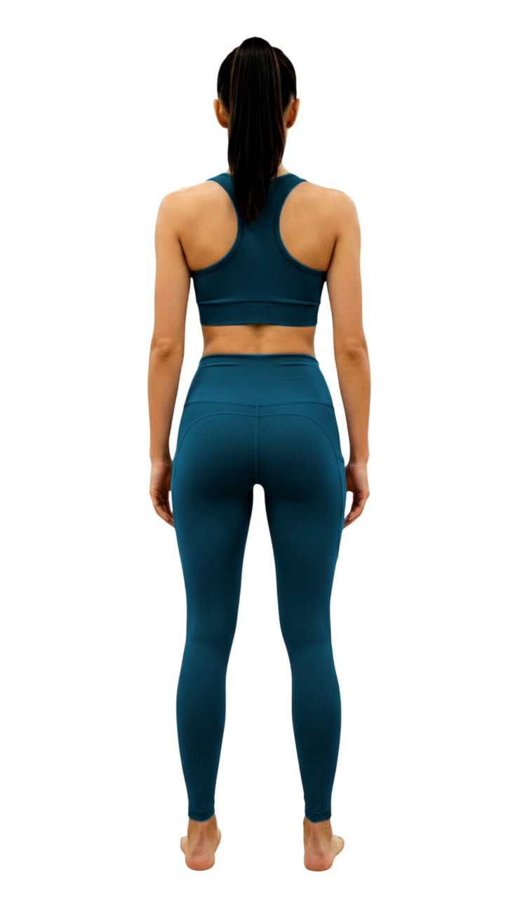Person wearing teal athletic outfit on a white background