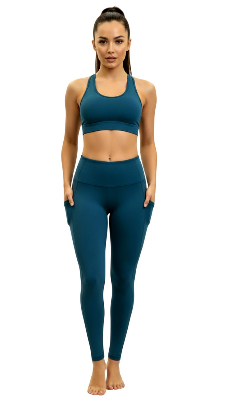 Woman wearing a teal sports bra and leggings set on a white background