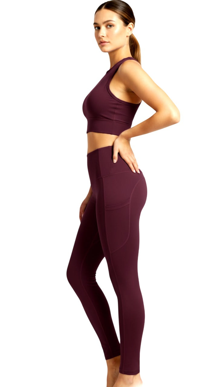 Woman wearing a maroon athletic outfit on a white background