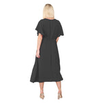 Woman wearing a black dress with cape sleeves on a white background